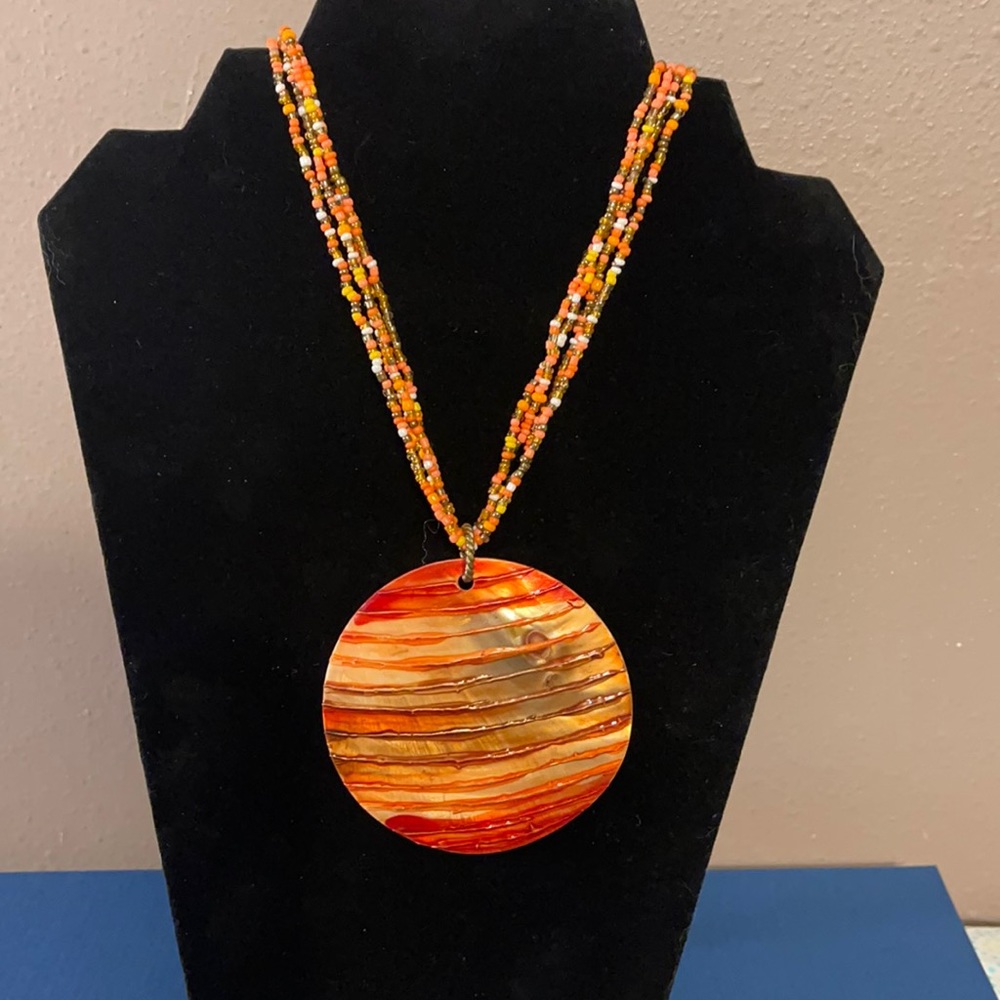 Long beaded necklace with shell pendant